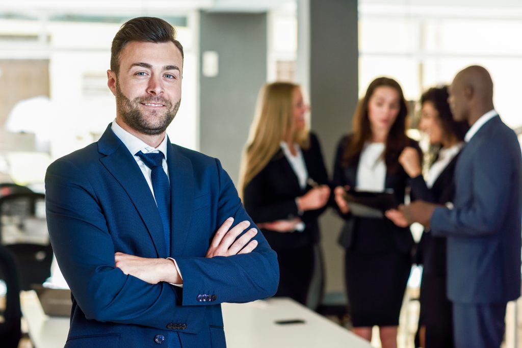Business leader in a modern office with his team